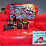Kaylie Murphy hold Cameron Bratcher with Dayton and Destiny Bratcher at the Armstrong Coal booth at Celebrate the Child 2013. (Kim Oliver photo)