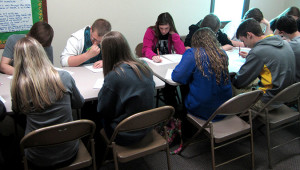 Students attending the World Languages regional showcase writing.