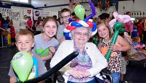 Joy Thurmond enjoys some balloon animals with children (L-to-R) Chaz Frizzel, Gracie LaGrown, Caden LaGrown and Chloe Frizzel.