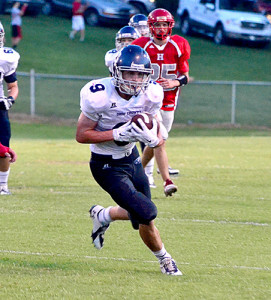 Eagle Brice Phelps makes one of his 12 catches on the night and runs downfield during OC's loss at Hancock County Friday night.