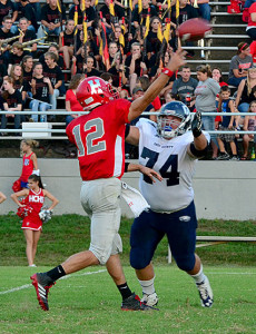 Eagle senior lineman Luke Shaffer hits Hancock County quarterback Nathaniel Morris as he throws the ball during the first half of OC's loss at Hancock County Friday.