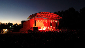 The sun sets behind the Beaver Dam Amphitheater as Joe Diffie takes the stage Saturday night.
