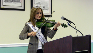 Miss Kentucky Ramsey Carpenter plays "My Old Kentucky Home" at the November Chamber of Commerce meeting in Hartford.