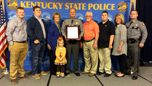 Kentucky State Police Sergeant Bryan Whittaker received a promotion to Lieutenant on Monday, Nov. 10. Pictured with Whittaker is his family from L-to-R: Austin Brownd, Nate Whittaker, Charlotte Whittaker, Carly Whittaker, Bryan Whittaker, Gerald Whittaker, Mason Whittaker, Mendy Brownd and Tpr. Jon Whittaker.