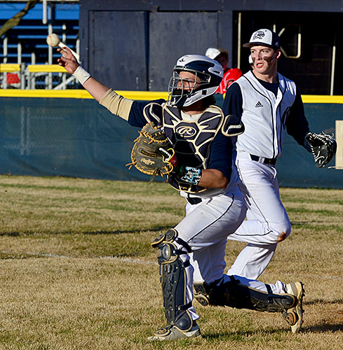 Eagle catcher Lawson Clayton throws out an Owensboro runner at third base following a bunted ball.