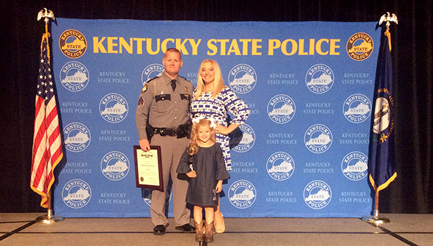 Kentucky State Police Sgt. Jonathan Whittaker is pictured with Kelly Freeman, right, and daughter Karly Whittaker yesterday as the KSP held its promotion ceremony at the Hyatt Regency in Lexington.