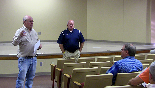 Art Smith, left, with the Environmental Protection Agency speaks during a Tuesday press conference about the arsenic contamination site on Shinkle Chapel Road in Hartford.